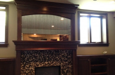 Antique frameless mirror over fireplace