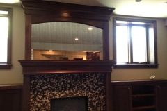 Antique frameless mirror over fireplace