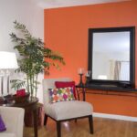 Decorative framed mirror accenting a colourful living room .