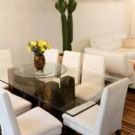Glass dining table in a contemporary home interior.