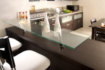 Custom glass countertop in a modern kitchen and dining area.