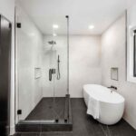 Tempered safety glass shower door in a modern bathroom.