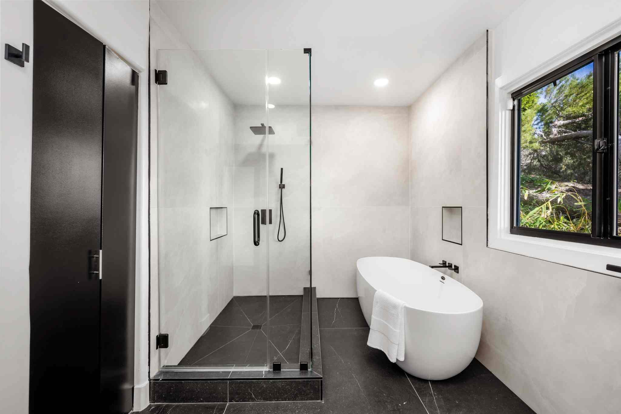 Tempered safety glass shower door in a modern bathroom.
