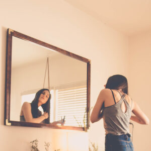 hanging mirror on plaster wall