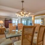 A dining area with an antique mirror that creates an intimate ambiance during meal time.