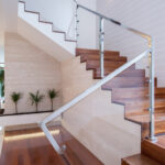 An interior staircase with glass railings is a key feature of contemporary design.