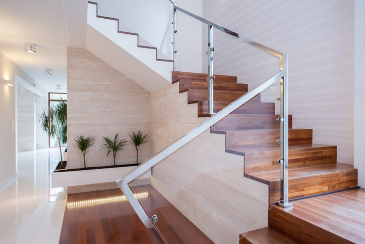 An interior staircase with glass railings is a key feature of contemporary design.