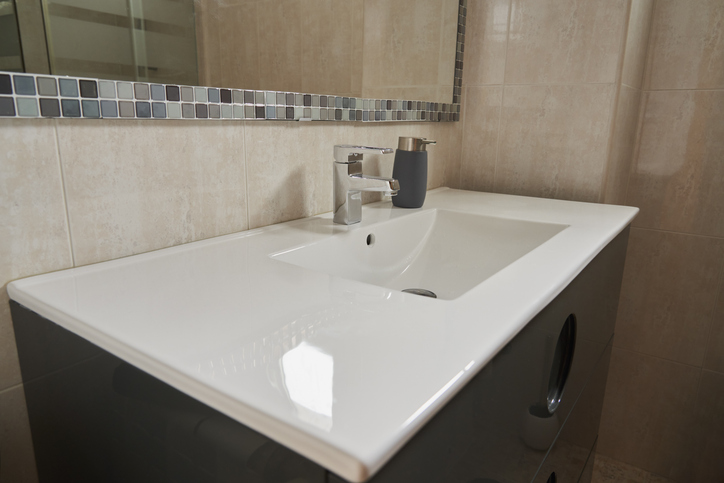 A glass countertop in the bathroom, both aesthetically pleasing and easy to maintain, helps create a clean environment with an elegant feel.