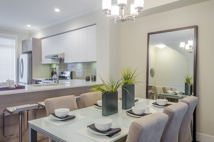 A custom-framed mirror used as a focal point on the dining table.